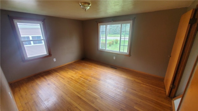 spare room with light wood-type flooring