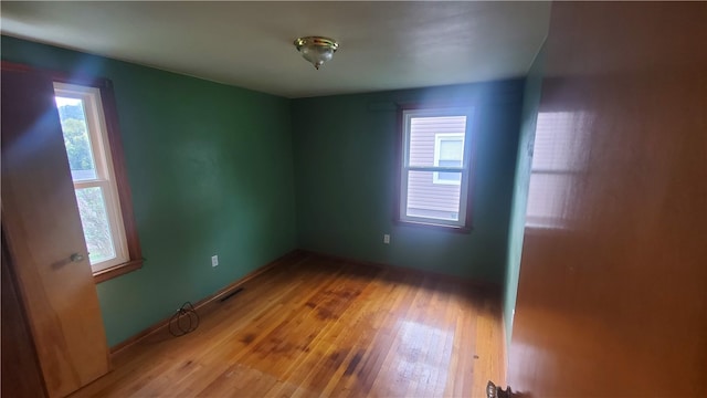 spare room with hardwood / wood-style flooring