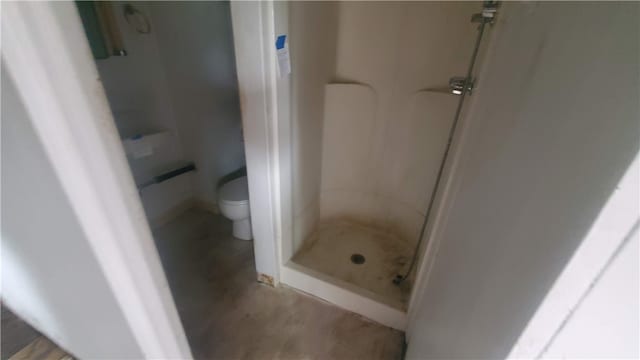 bathroom featuring toilet and walk in shower