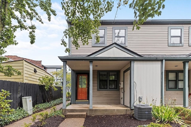 view of front of home with a porch and cooling unit