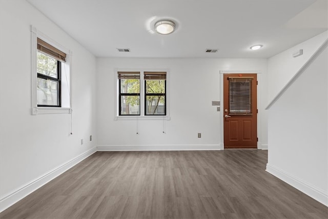 empty room with hardwood / wood-style flooring