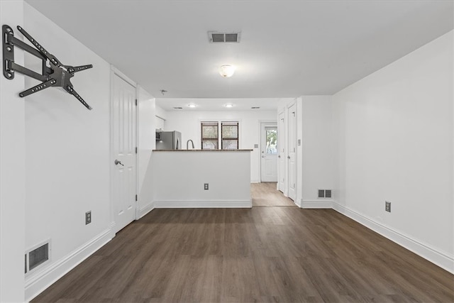 unfurnished living room with dark hardwood / wood-style flooring