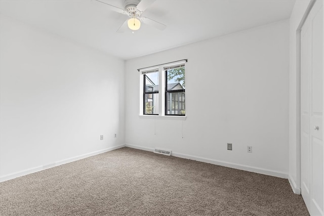 unfurnished room featuring ceiling fan and carpet floors