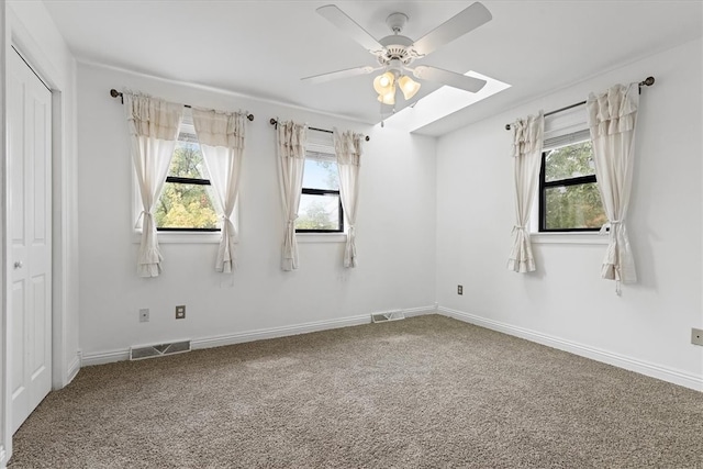 spare room featuring ceiling fan and carpet flooring