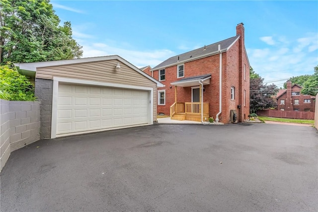 exterior space with a garage and an outdoor structure