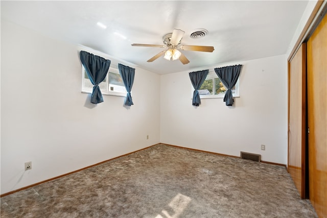 unfurnished bedroom featuring a closet, carpet floors, and ceiling fan