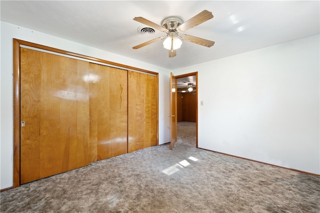 unfurnished bedroom with carpet flooring, a closet, and ceiling fan