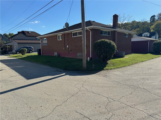 view of side of home with a lawn