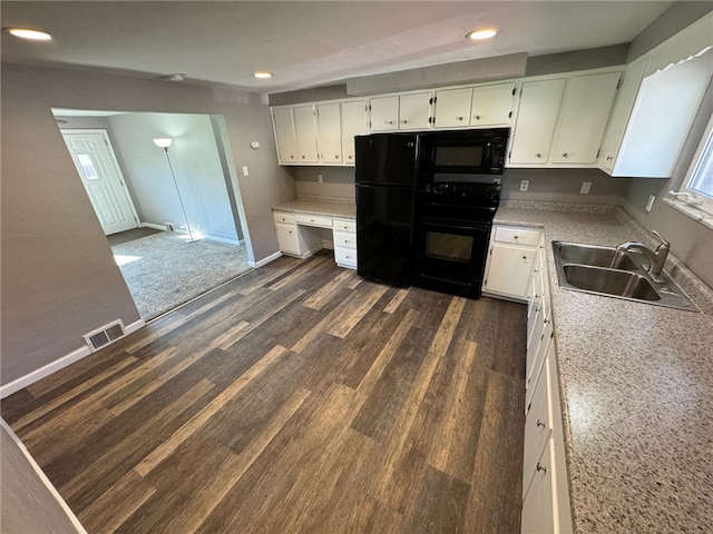 kitchen with white cabinets, built in desk, dark hardwood / wood-style flooring, black appliances, and sink