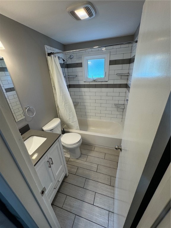 full bathroom with vanity, toilet, and shower / bath combination with curtain