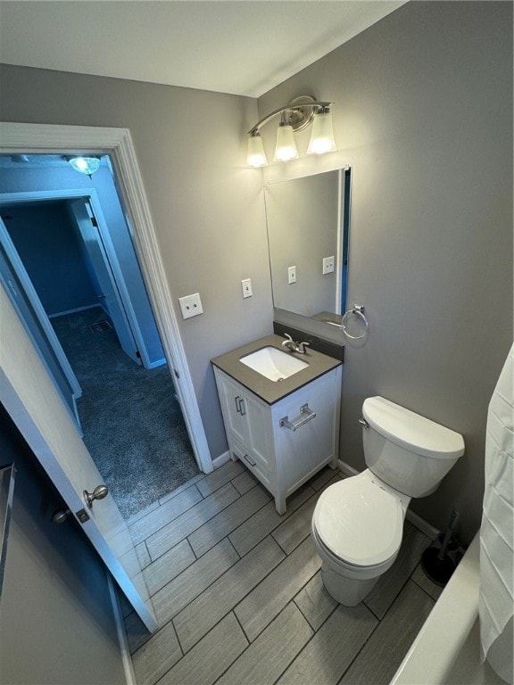 bathroom featuring vanity and toilet