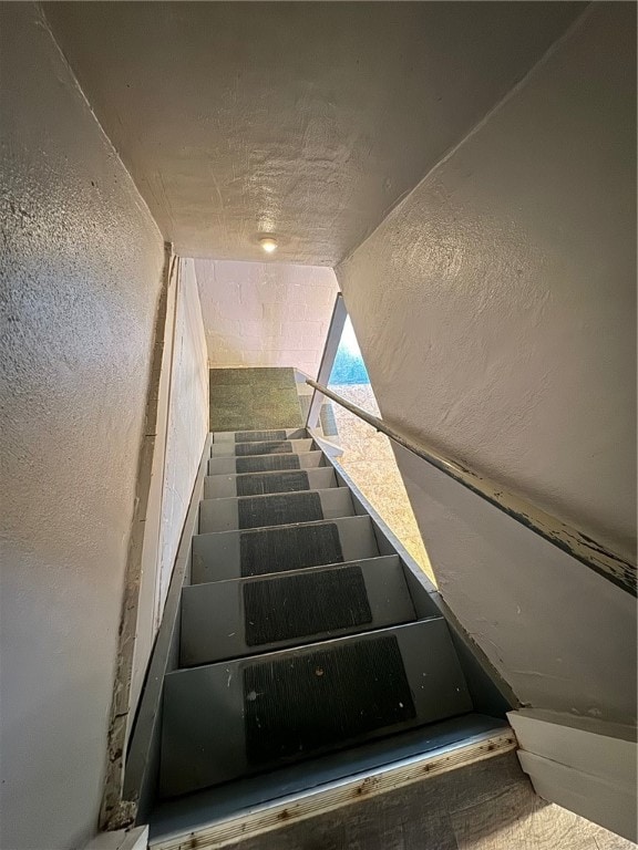 stairway featuring lofted ceiling