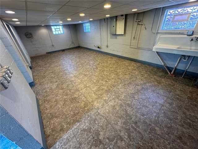 basement featuring sink and a drop ceiling