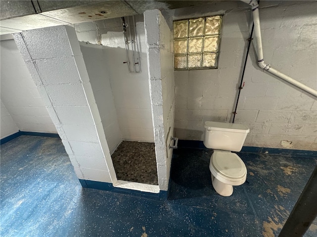 bathroom featuring toilet and walk in shower