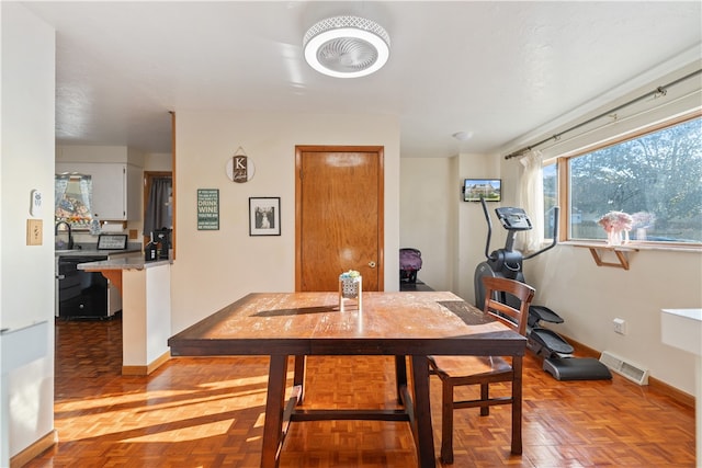 dining area featuring light parquet floors