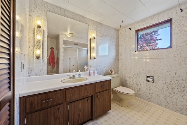 bathroom featuring toilet, walk in shower, and vanity