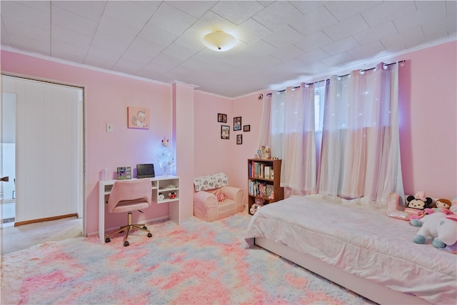 carpeted bedroom featuring a closet and ornamental molding