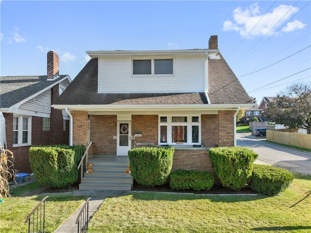 view of front of home with covered porch and a front yard