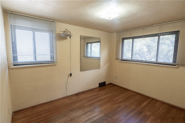 spare room with hardwood / wood-style flooring