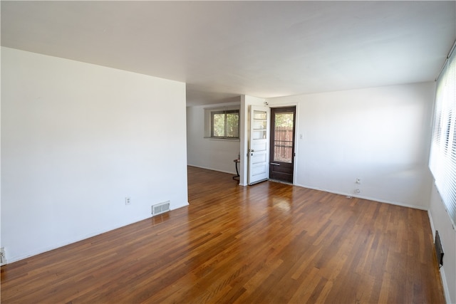 unfurnished room with dark wood-type flooring