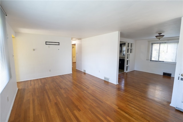 unfurnished room with dark hardwood / wood-style floors