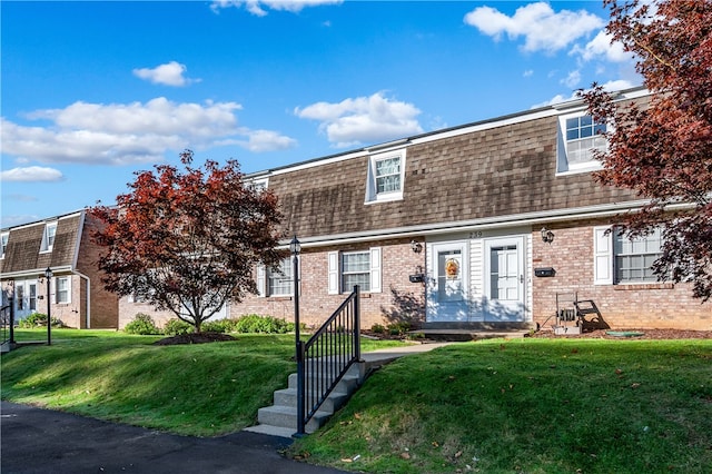 view of property featuring a front lawn