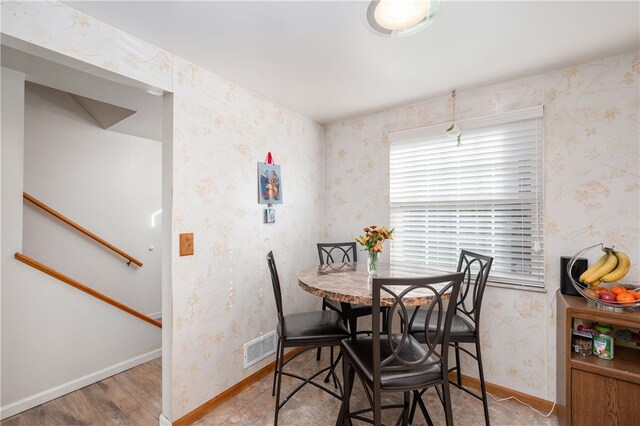 dining area with hardwood / wood-style floors