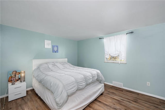 bedroom featuring dark hardwood / wood-style flooring