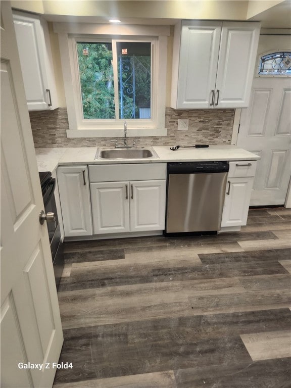 kitchen with dishwasher, white cabinets, and sink