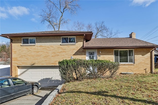 split level home featuring a garage and a front lawn