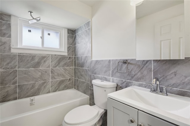 full bathroom featuring washtub / shower combination, backsplash, toilet, vanity, and tile walls