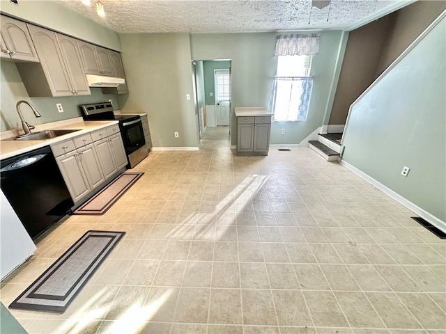 kitchen with dishwasher, sink, electric range, and a textured ceiling