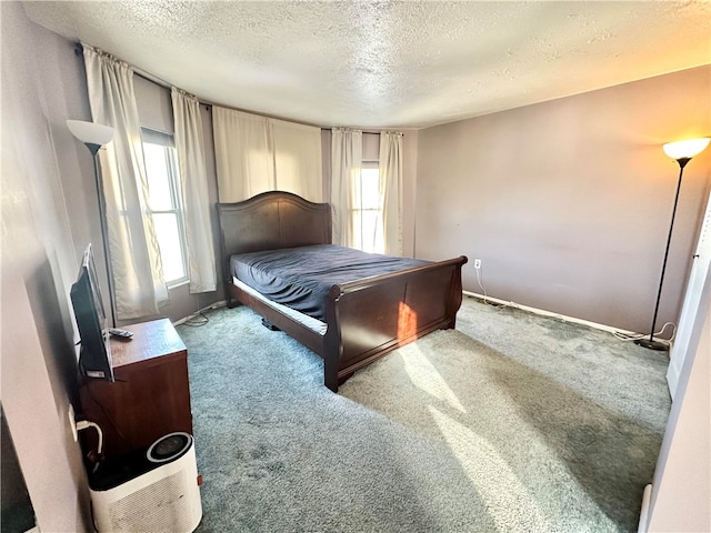 carpeted bedroom featuring a textured ceiling