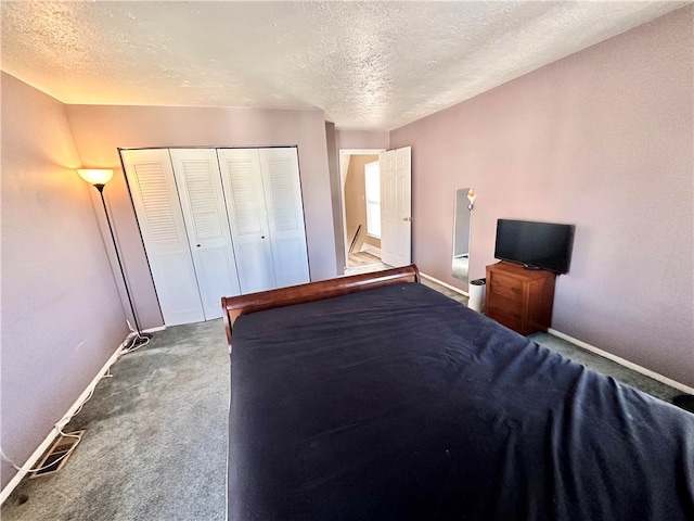 unfurnished bedroom featuring a closet, a textured ceiling, and carpet flooring