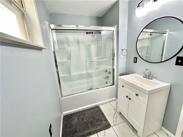 bathroom with vanity and combined bath / shower with glass door