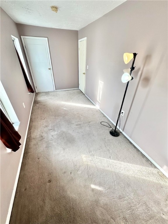 carpeted spare room with a textured ceiling