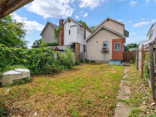 rear view of property with cooling unit