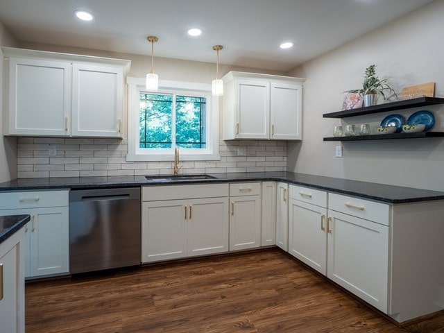 kitchen featuring white cabinetry, sink, stainless steel dishwasher, and dark hardwood / wood-style flooring