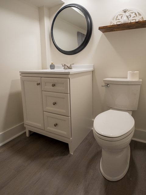 bathroom with vanity, hardwood / wood-style floors, and toilet