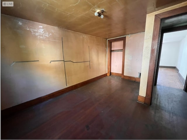 empty room with dark hardwood / wood-style floors