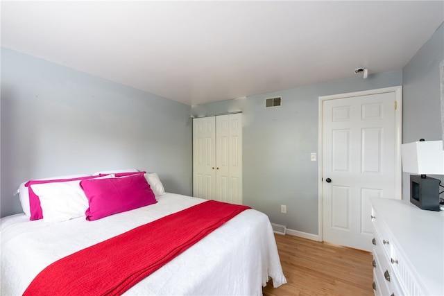 bedroom featuring light hardwood / wood-style flooring and a closet