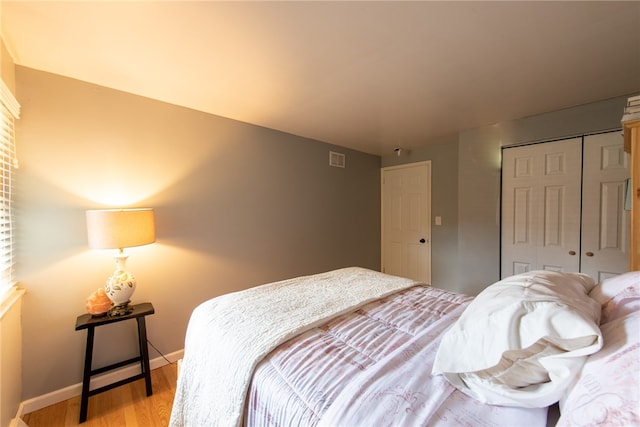 bedroom featuring a closet and light wood-type flooring