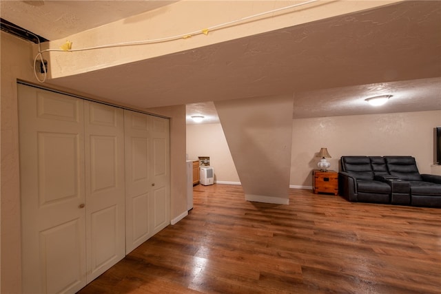 basement with a textured ceiling and wood-type flooring