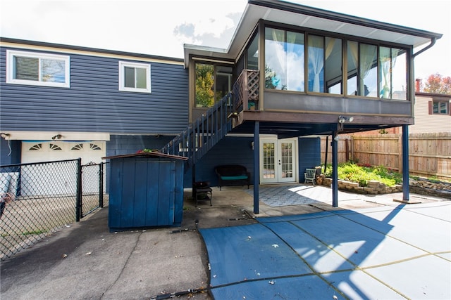 back of property with french doors, a patio area, and a sunroom