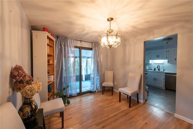 sitting room with hardwood / wood-style flooring, a chandelier, and sink