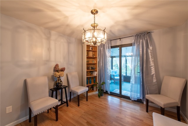 sitting room with a chandelier and hardwood / wood-style floors