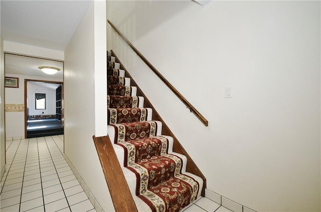 stairway with tile patterned flooring