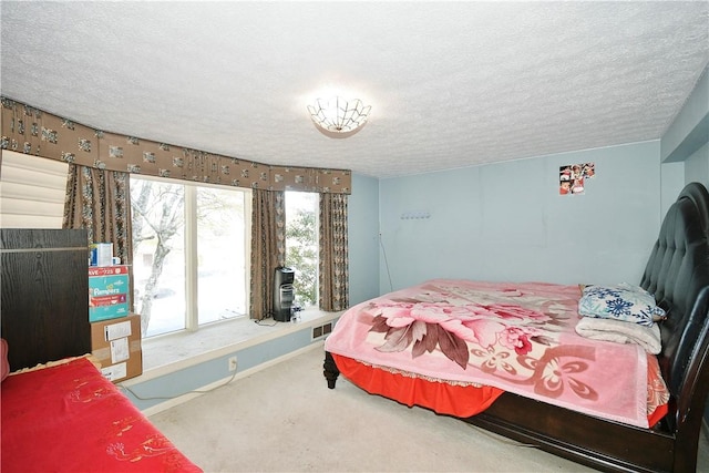 bedroom featuring carpet floors and a textured ceiling