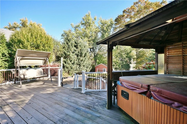 wooden terrace with a gazebo and a hot tub