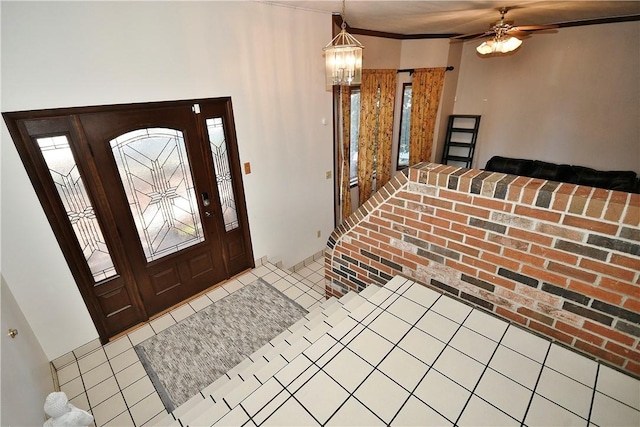 foyer with ceiling fan with notable chandelier